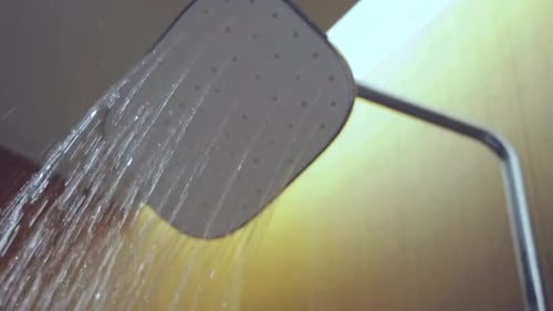 Shower Head with Running Water in Bathroom