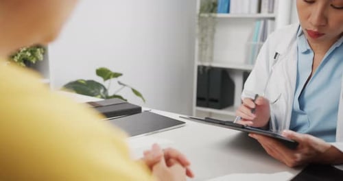 Doctor Consulting with Patient in Clinic