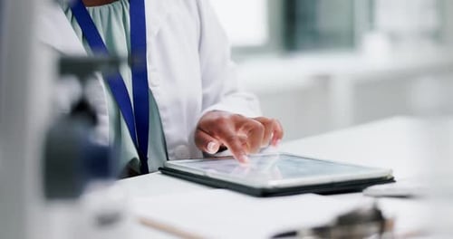 Medical Professional Using Tablet in Bright Workplace