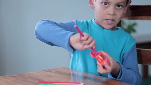 boy with pencil sharpener at school with people stock video stock footage