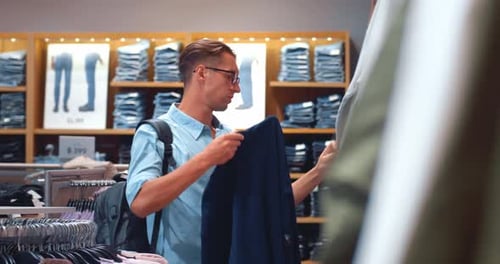 Selecting Business Suit Man Examines Quality and Fit in Clothing Store Every Component in Choice of