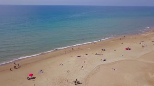 Mediterranean beach during summer with people in the water