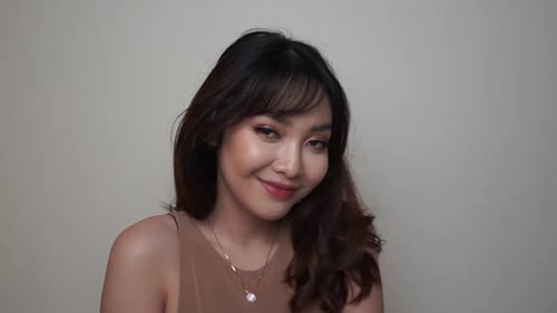 Smiling Woman Shakes Hair Indoors