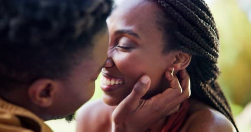 Loving Couple Sharing a Kiss in a Green Park