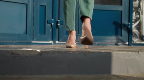 Woman Walking Down Steps in Stylish Business Suit