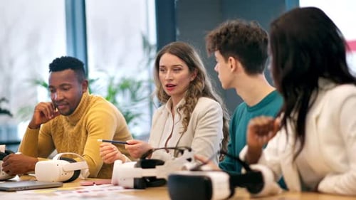 Business conference in VR in an office. Discussing multiracial group of people, VR glasses and contr