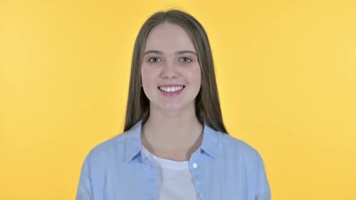 Smiling Young Woman Close Up on Yellow