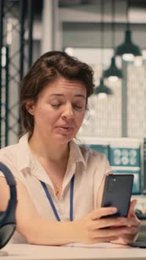 Vertical Video Smiling Woman Participating in Video Call From Workstation in Office
