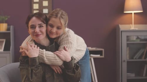 Daughter Hugs Mother Wearing Military Uniform