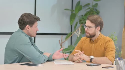 Men Discussing Business in an Office