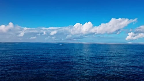 Aerial Top view of a transparent blue sea with beautiful waves at sunny day in summer. air of ocean
