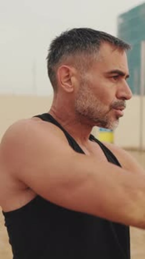 Man Stretching Arms in Urban Outdoor Setting