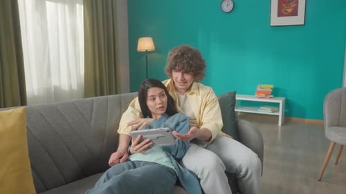 A Woman and a Man Watch a Movie Photo Video on a Tablet Discuss What They Saw A Young Asian Woman