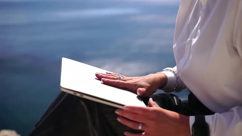 Mulher de negócios nômade digital trabalhando em um laptop à beira-mar