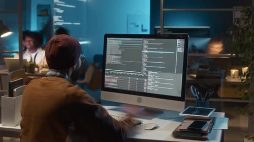 Coding Programmer Typing At Computer In Workplace