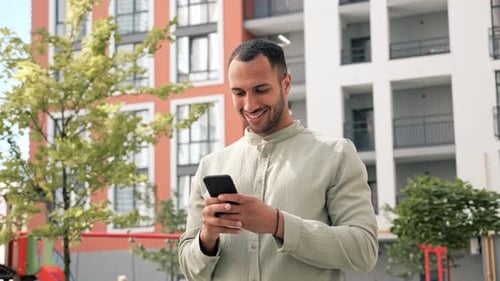Afro American Man Using Smartphone in Urban Street Online Shopping Social Media