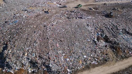 Aerial View of a Vast Landfill Where Bulldozers are Working and Trucks are Bringing New Waste Huge