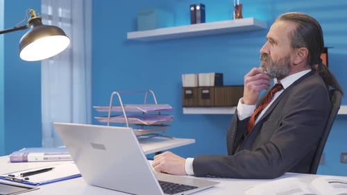 Man in Gray Suit Working at Desk