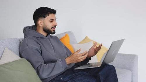 Young Man on Laptop Video Call at Home