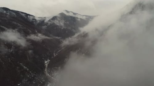 sharp peaks with clouds around them