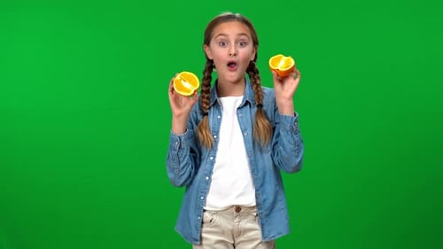 Girl Playing with Oranges on Green Screen
