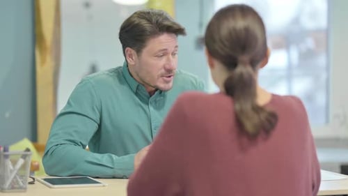 Man Actively Conversing During Office Meeting