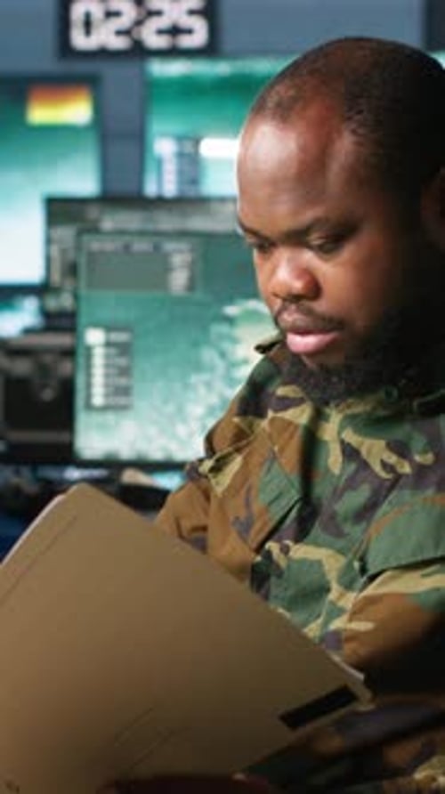 Man Reads Classified File in Office at Night