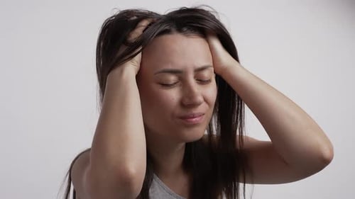 Woman Clutching Head in Pain and Stress