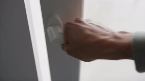 Hand of Man Opening a Modern Slider Window Of the Room of House