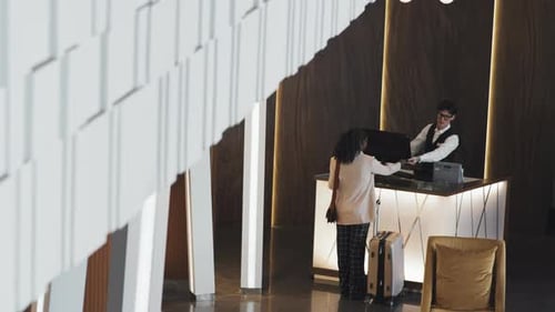 Woman Checking In At Hotel