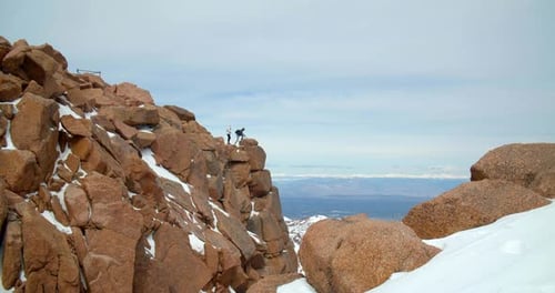 Couple enjoying majestic views from rocky mountains peak in Colorado