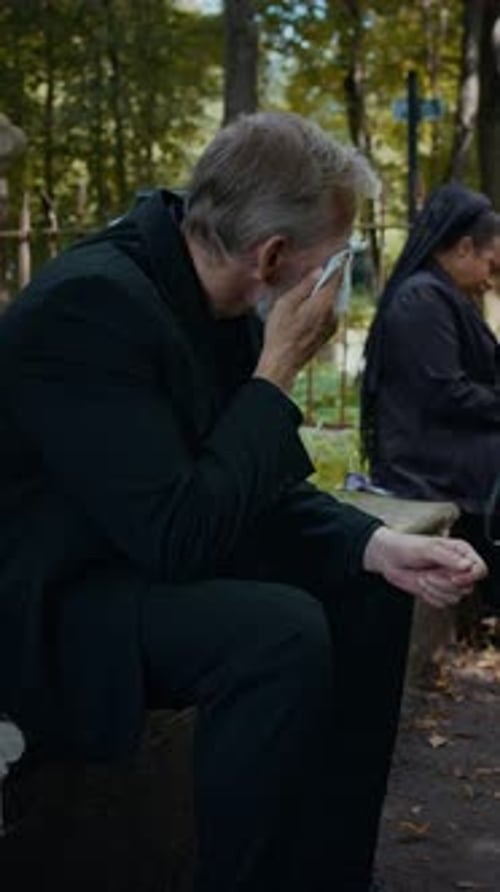 Bereaved Man Crying after Funeral Ceremony in Cemetery