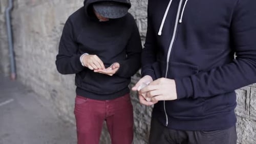 Drug dealer sells dose to addict on street in illegal drug trafficking trade