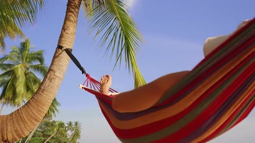 Close View Of Hammock Rope And Woman Leg Against Blue Sky And Palm Leaves, Intimate Vacation Detail
