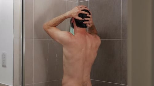 Shirtless Man Washing His Hair in Shower