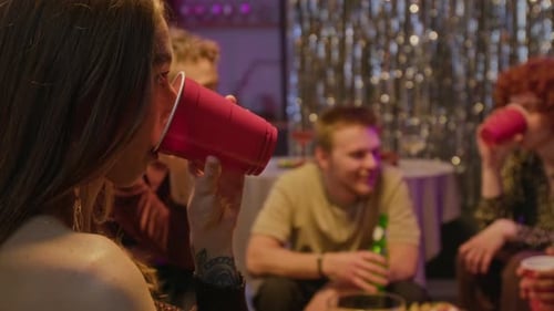 Friends Eating Pizza and Drinking at Party Together