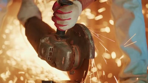 Close View of Metal Grinding Process Hands Manipulating Grinder with Sparks and Metal Shavings