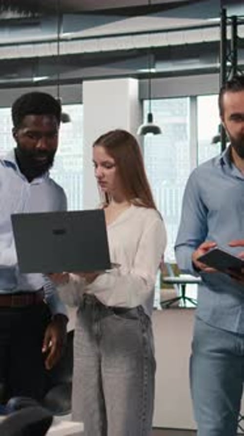 Vertical Video Portrait of Teamworking Programmers in Office Developing Apps Using AI