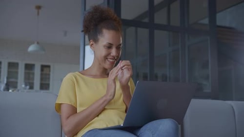 Handheld Close Up of African American Woman Receiving Good News and Celebrate Achievement on Laptop