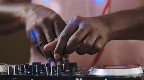 Unrecognizable Unknown Cool African DJ Standing at Mixer Controller Composing New Sound Song Audio