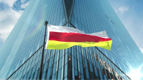 Corporate Flag Waving in Front of Modern Skyscraper