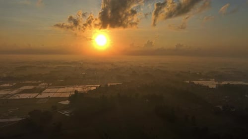 Aerial View Of A Sunrise Over A Valley With Fog And Fields