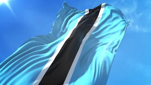 Botswana Flag Waving in Blue Sky with Sun Flare