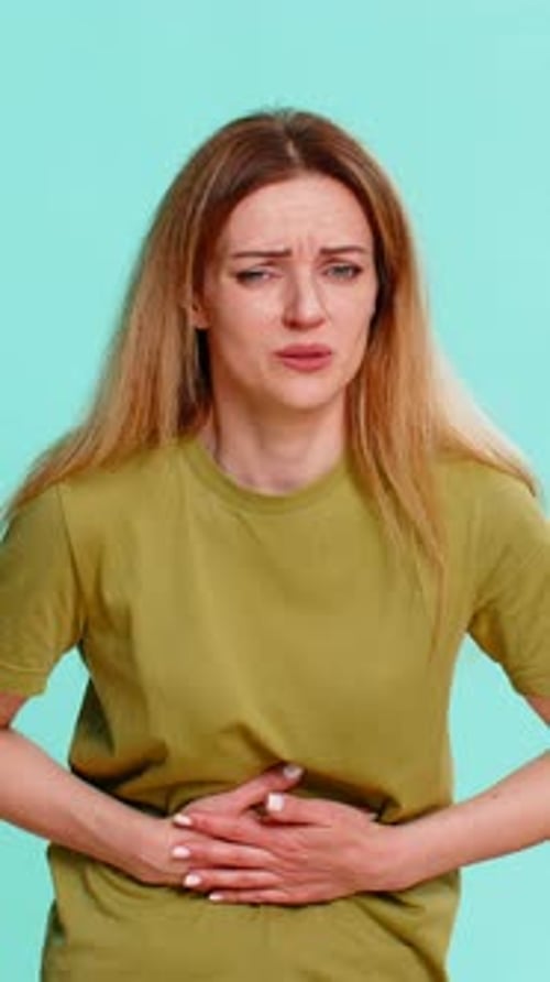 Woman Experiencing Abdominal Pain in Studio