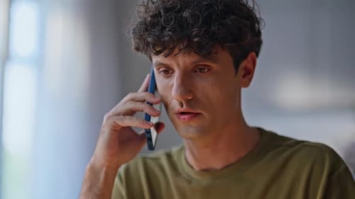 Young Adult Talking on a Smart Phone Indoors