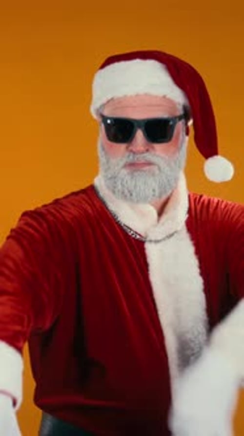 Cool Santa Claus Dancing with Sunglasses on Orange Background
