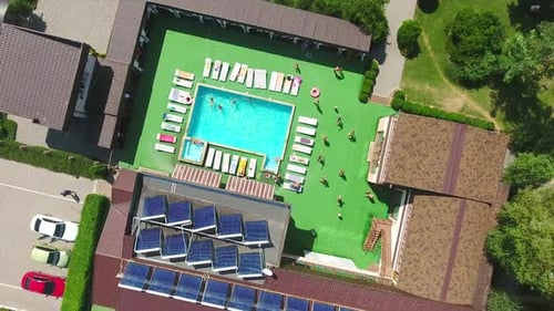 Lifestyle of outdoor pool relaxation for tourists. Top view of swimming family outdoor.