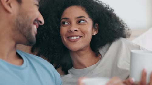 Happy Couple Relaxing in Bed Together