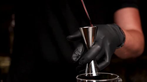 the bartender prepares a cocktail at the bar