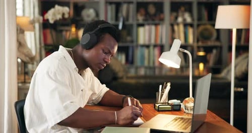 University, library and man with headphones on laptop for online learning, studying and education